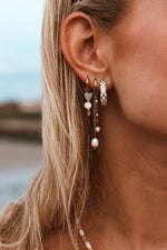 Single white cross hoop gold